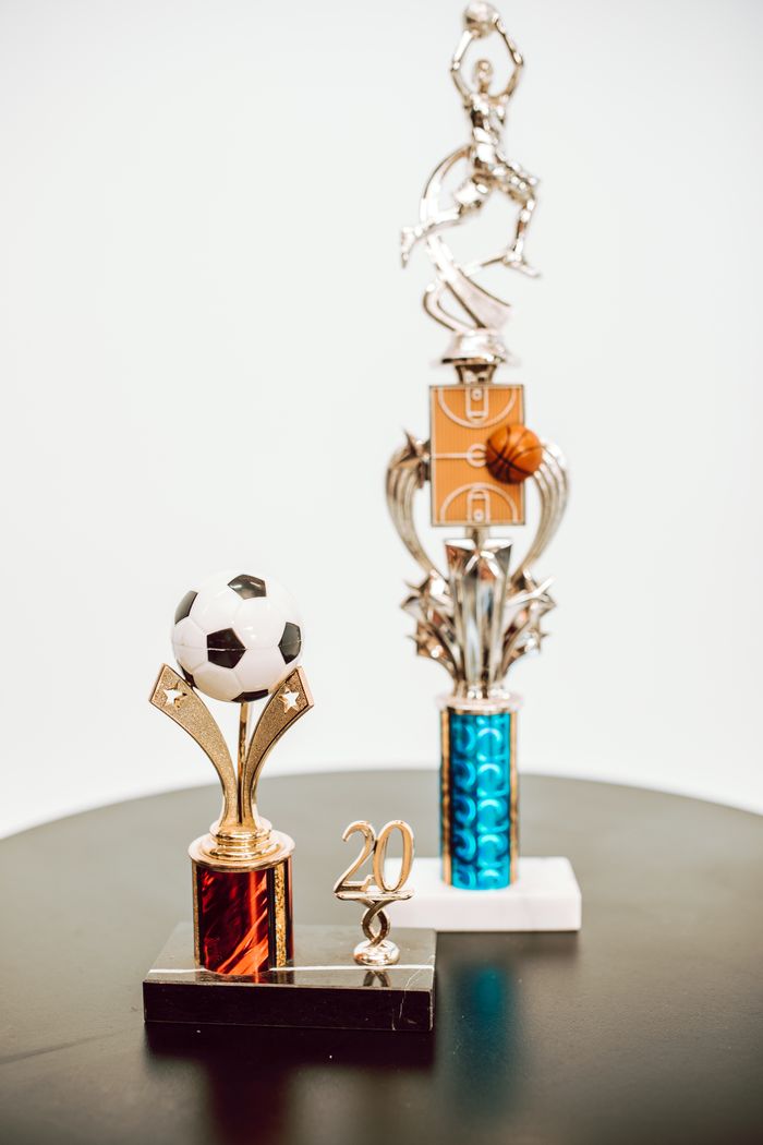 Crafting Captivating Headlines: Your awesome post title goes here Close-up of soccer and basketball trophies celebrating sports success.